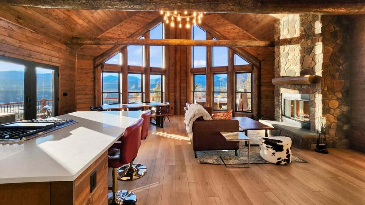 The main level of the home boasts an open layout surrounded by stunning views of the mountains.