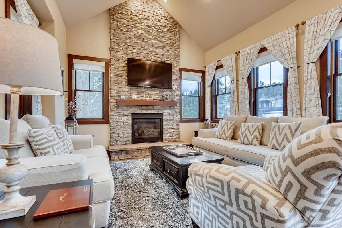 Family room with gas fireplace, mounted TV, and comfortable furniture